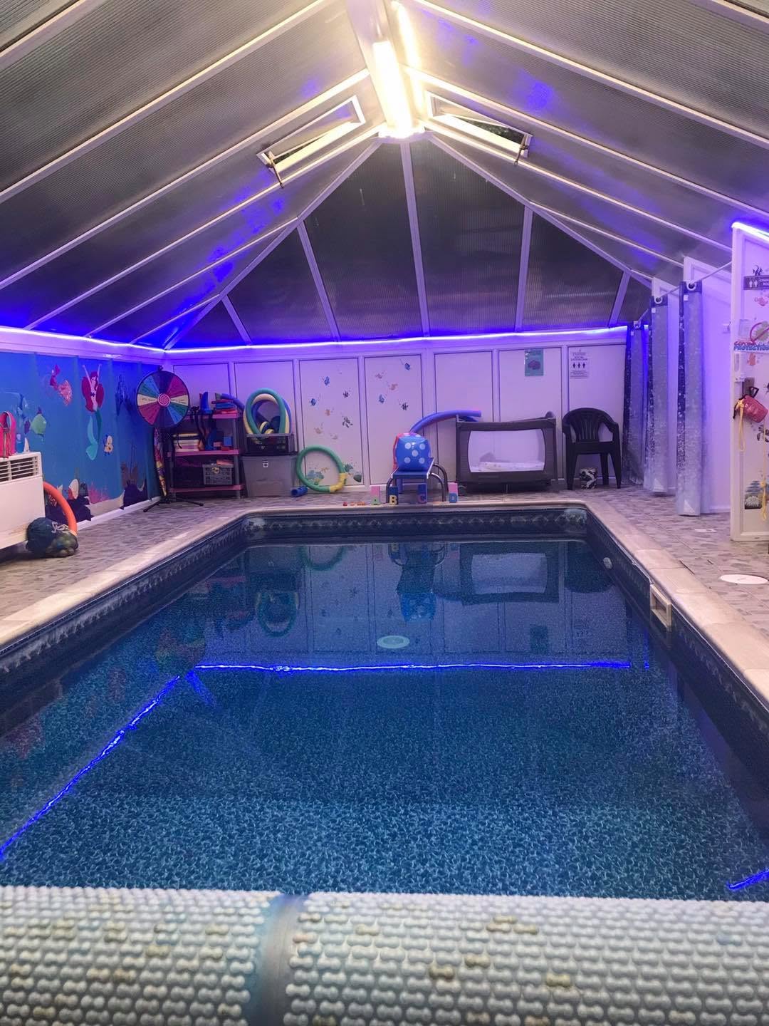 The indoor pool at Wendy's Swim School, seen from the poolside with the roof and teaching equipment visible